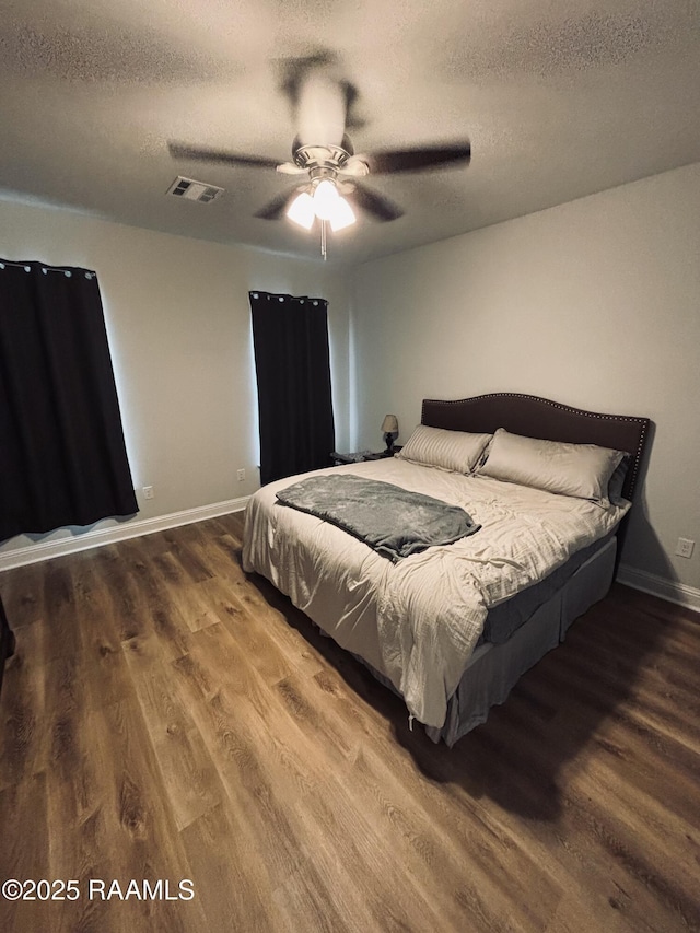 131 Wild Cherry Ln, Lafayette, LA 70508 - bedroom with wood finished floors, a textured ceiling, baseboards, and a ceiling fan