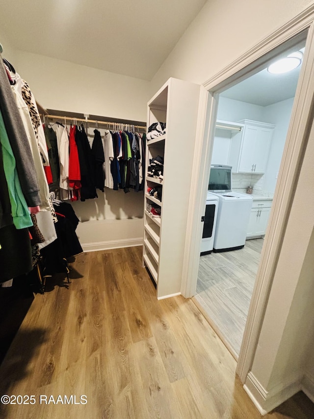 131 Wild Cherry Ln, Lafayette, LA 70508 - spacious closet featuring washer and clothes dryer and light wood-style floors