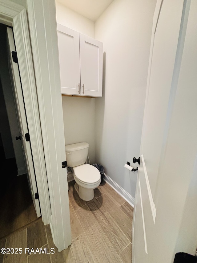 131 Wild Cherry Ln, Lafayette, LA 70508 - bathroom with wood finished floors, toilet, and baseboards