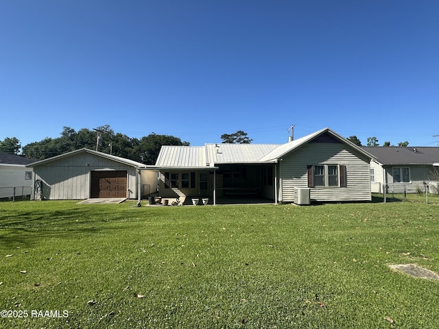 back of house with metal roof, fence, a yard, and cooling unit