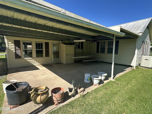 rear view of house featuring a yard, ceiling fan, and a patio area