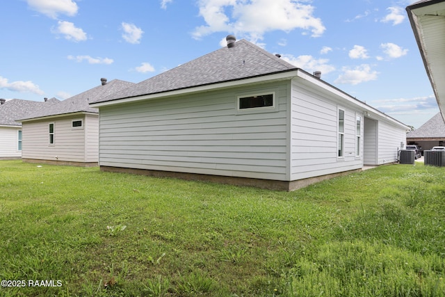 view of property exterior with cooling unit, a lawn, and a shingled roof