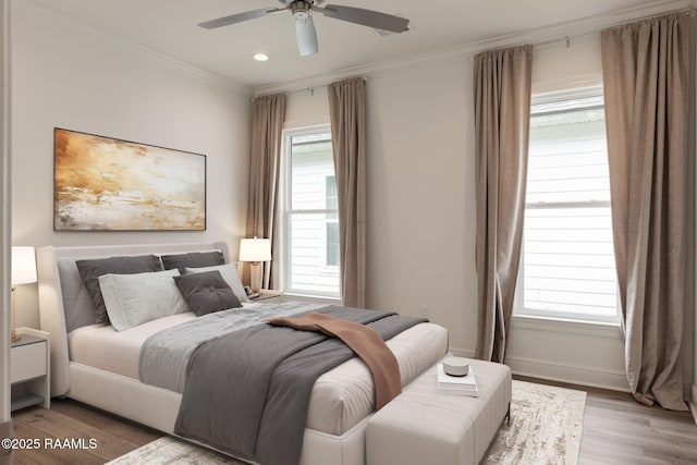 bedroom featuring light wood finished floors, ornamental molding, recessed lighting, baseboards, and a ceiling fan