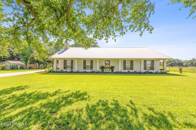 319 Roger Rd, Lafayette, LA 70507 - ranch-style house featuring a front lawn, a chimney, brick siding, and a metal roof