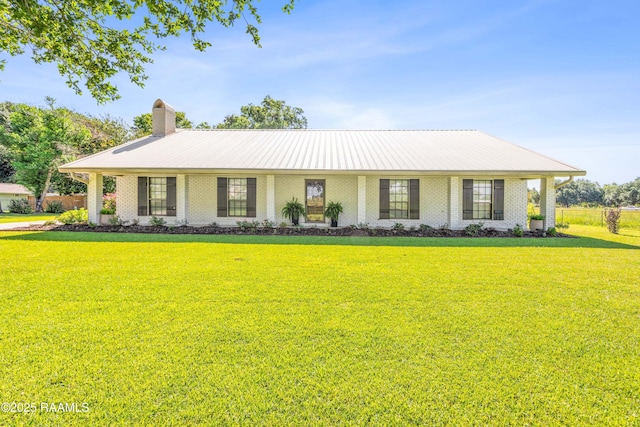 319 Roger Rd, Lafayette, LA 70507 - view of front of home featuring a front yard, a chimney, brick siding, and a metal roof
