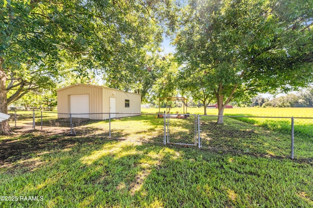 319 Roger Rd, Lafayette, LA 70507 - fenced backyard with a garage, a gate, and an outbuilding