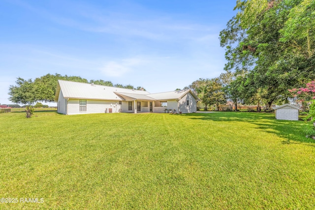 319 Roger Rd, Lafayette, LA 70507 - view of green lawn featuring a shed