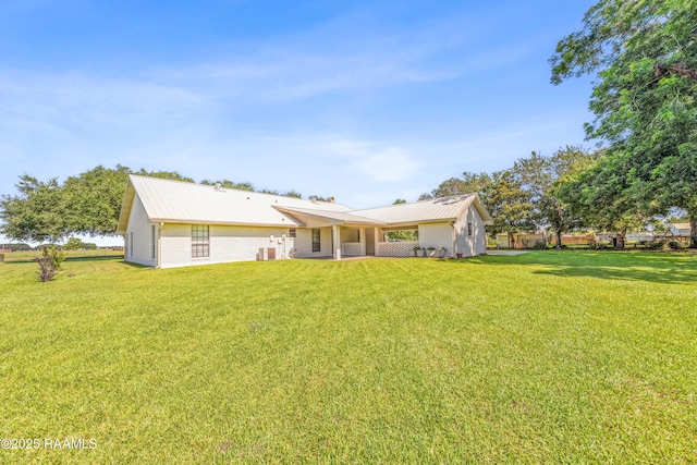 319 Roger Rd, Lafayette, LA 70507 - rear view of house with a yard and a metal roof