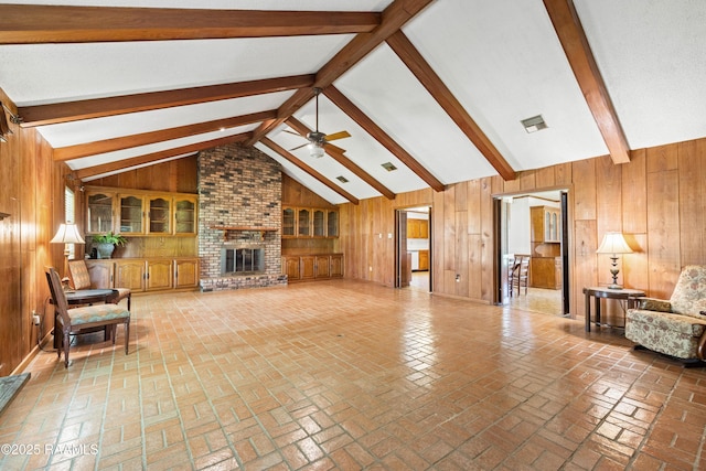 319 Roger Rd, Lafayette, LA 70507 - living room with wood walls, ceiling fan, and a brick fireplace
