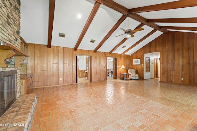 319 Roger Rd, Lafayette, LA 70507 - unfurnished living room with a fireplace, wood walls, ceiling fan, and brick patterned floors