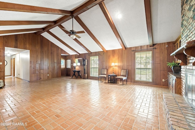 319 Roger Rd, Lafayette, LA 70507 - living area with wood walls, ceiling fan, and a textured ceiling