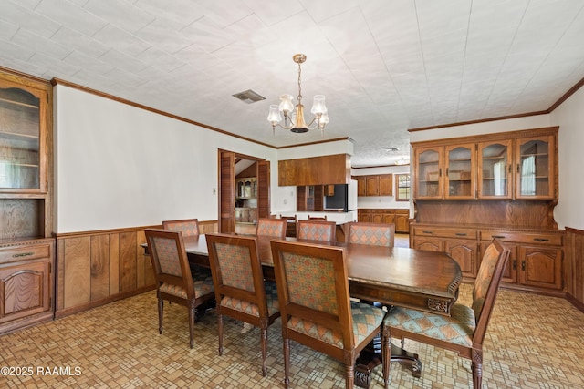 319 Roger Rd, Lafayette, LA 70507 - dining room with a chandelier, ornamental molding, and a wainscoted wall