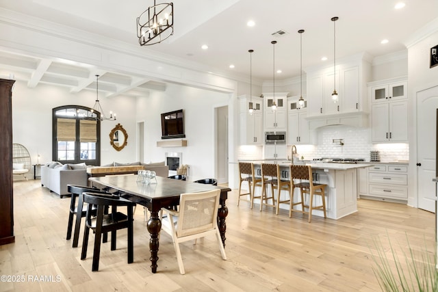 dining room featuring an inviting chandelier, visible vents, beamed ceiling, light wood-style floors, and recessed lighting