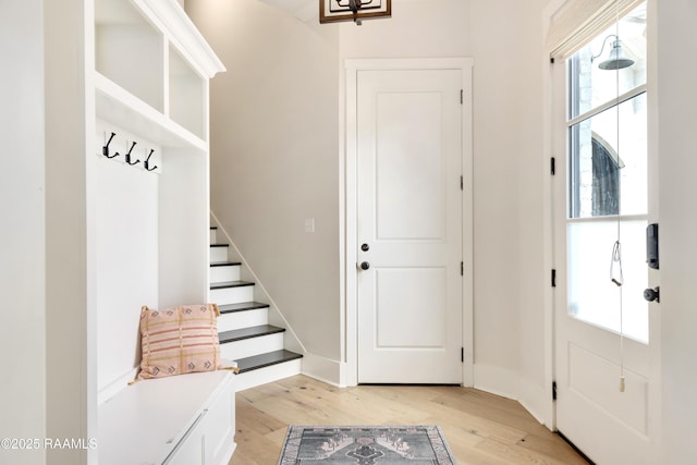 mudroom with light wood-style floors and a chandelier