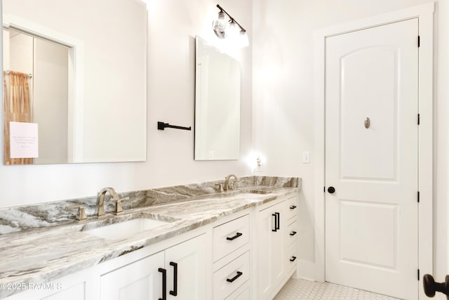 bathroom with double vanity, a sink, and tile patterned flooring
