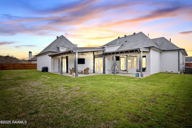 rear view of house with french doors, fence, a yard, a patio, and a pergola