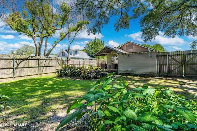 view of yard with a fenced backyard and a gate