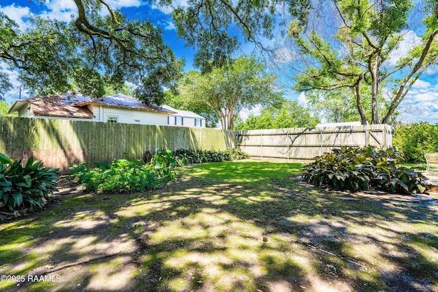 view of yard with a fenced backyard