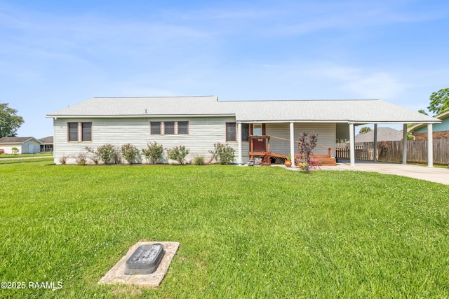 202 Sapphire Dr, Lafayette, LA 70506 - view of front facade featuring driveway, fence, a front yard, and an attached carport