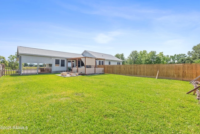 202 Sapphire Dr, Lafayette, LA 70506 - rear view of house with a fenced backyard, a patio, a jacuzzi, and a yard