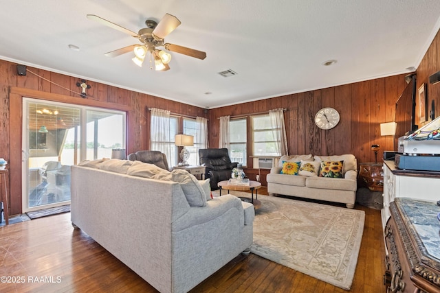 202 Sapphire Dr, Lafayette, LA 70506 - living room with a ceiling fan, crown molding, wood walls, visible vents, and dark wood-type flooring