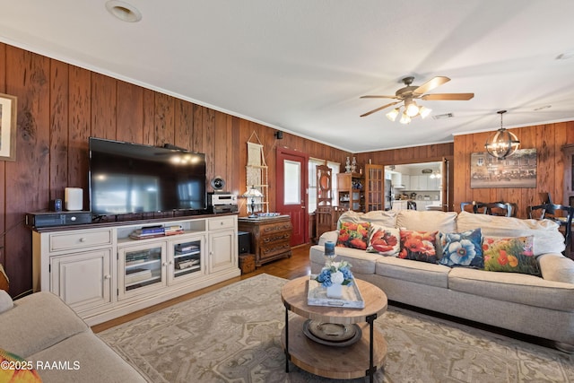 202 Sapphire Dr, Lafayette, LA 70506 - living room featuring wooden walls, crown molding, ceiling fan, and visible vents