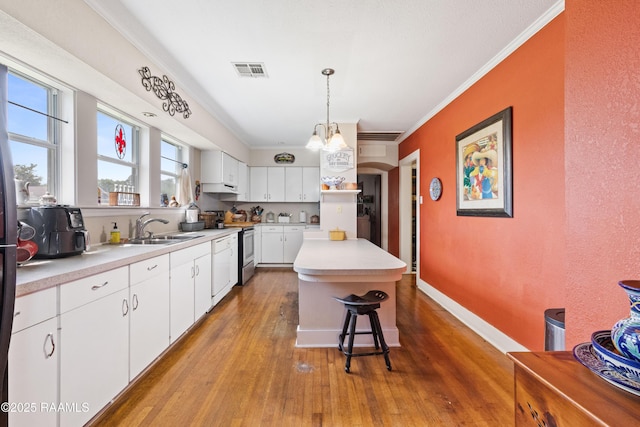 202 Sapphire Dr, Lafayette, LA 70506 - kitchen with light wood-style flooring, a sink, visible vents, under cabinet range hood, and light countertops