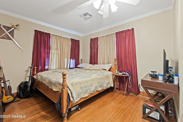 202 Sapphire Dr, Lafayette, LA 70506 - bedroom featuring crown molding, a ceiling fan, visible vents, and wood finished floors