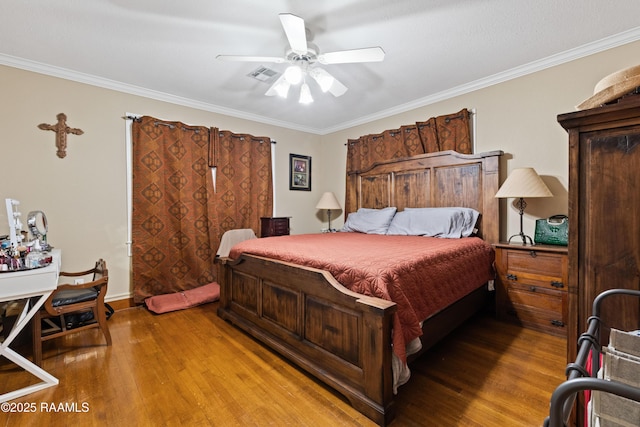 202 Sapphire Dr, Lafayette, LA 70506 - bedroom featuring ceiling fan, ornamental molding, visible vents, and wood finished floors