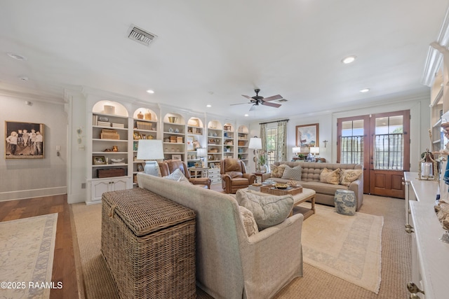 living room featuring ceiling fan, ornamental molding, visible vents, and recessed lighting