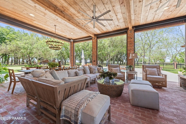 view of patio with ceiling fan, fence, and an outdoor living space