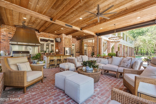 living area featuring wood ceiling, brick floor, ceiling fan with notable chandelier, and brick wall