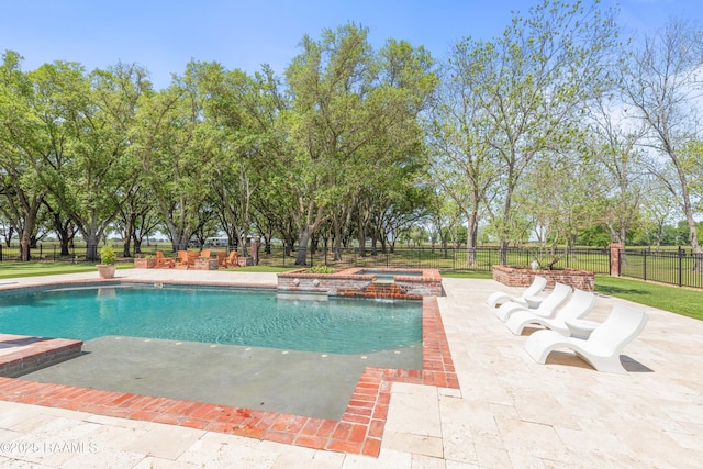 view of swimming pool with a pool with connected hot tub, fence, and a patio area