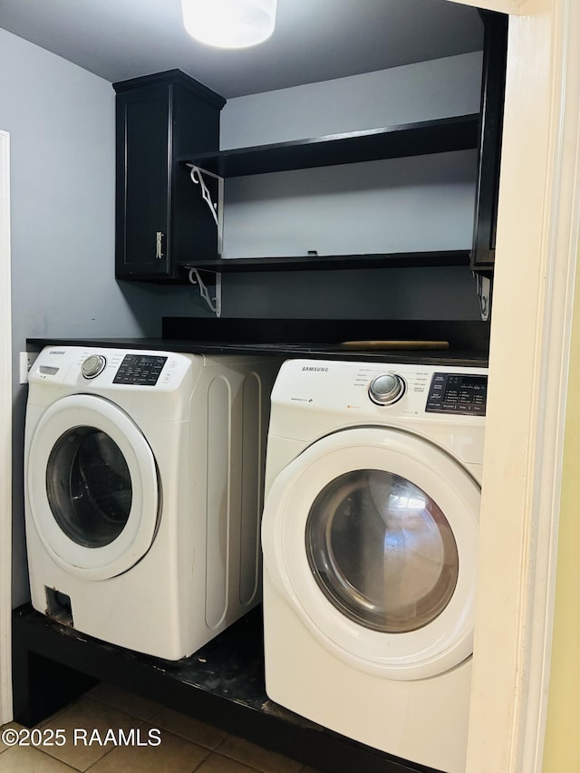 104 Bismark Dr, Broussard, LA 70518 - clothes washing area with washer and clothes dryer, cabinet space, and dark tile patterned flooring