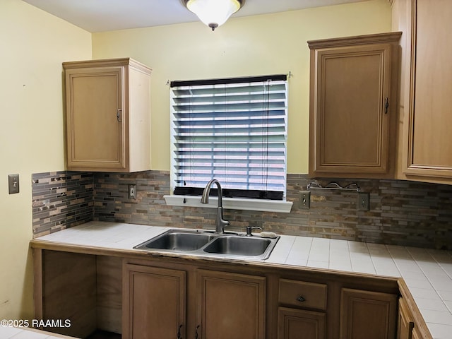 104 Bismark Dr, Broussard, LA 70518 - kitchen featuring tile counters, a sink, and backsplash