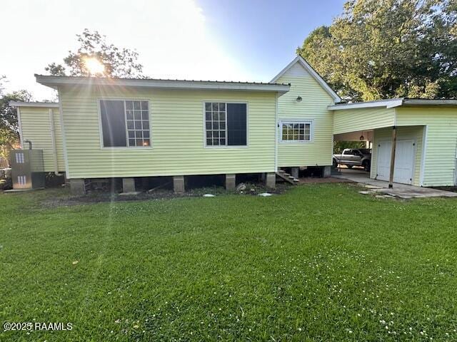505 Fairview Ave, Abbeville, LA 70510 - rear view of property featuring an attached carport and a lawn