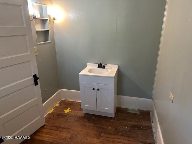 505 Fairview Ave, Abbeville, LA 70510 - bathroom featuring wood finished floors, vanity, and baseboards