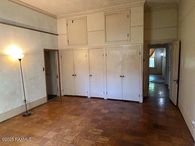505 Fairview Ave, Abbeville, LA 70510 - unfurnished bedroom featuring a closet, ornamental molding, and baseboards