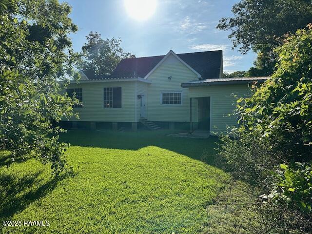 505 Fairview Ave, Abbeville, LA 70510 - back of property with a lawn and entry steps