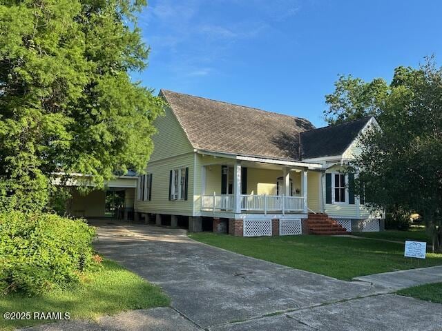 505 Fairview Ave, Abbeville, LA 70510 - view of front of home with covered porch, a front yard, and concrete driveway