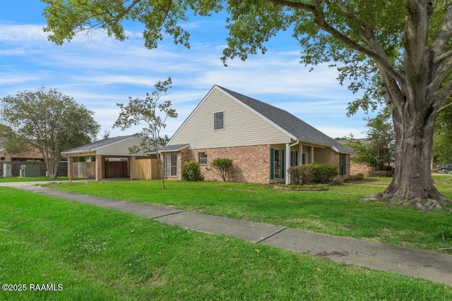 204 Eva Dr, Lafayette, LA 70508 - view of front of property featuring a front yard, brick siding, and fence