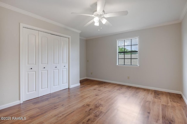 204 Eva Dr, Lafayette, LA 70508 - unfurnished bedroom with crown molding, a closet, baseboards, and wood finished floors