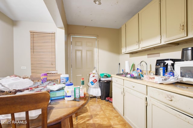 1405 Pelican St, New Iberia, LA 70560 - kitchen featuring a sink, light countertops, and white microwave