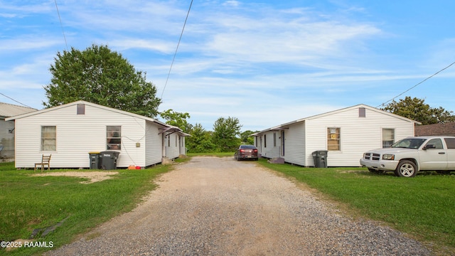 1405 Pelican St, New Iberia, LA 70560 - view of home's exterior featuring dirt driveway and a lawn