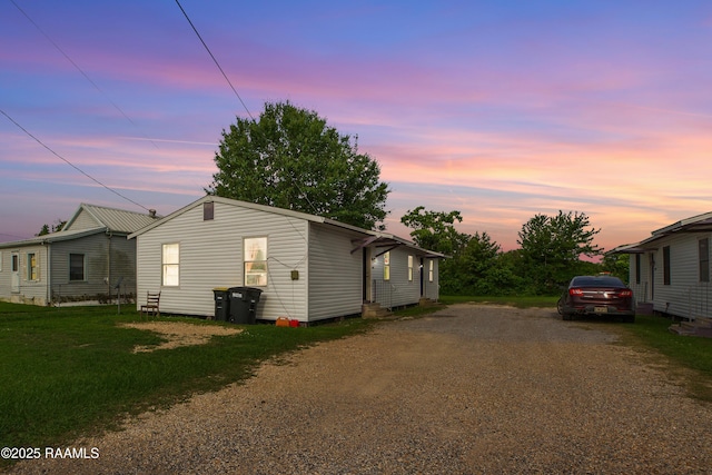 1405 Pelican St, New Iberia, LA 70560 - property exterior at dusk with dirt driveway