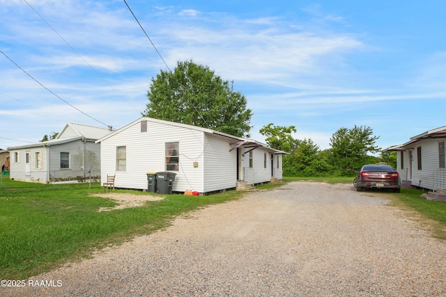 1405 Pelican St, New Iberia, LA 70560 - view of home's exterior with driveway and a yard