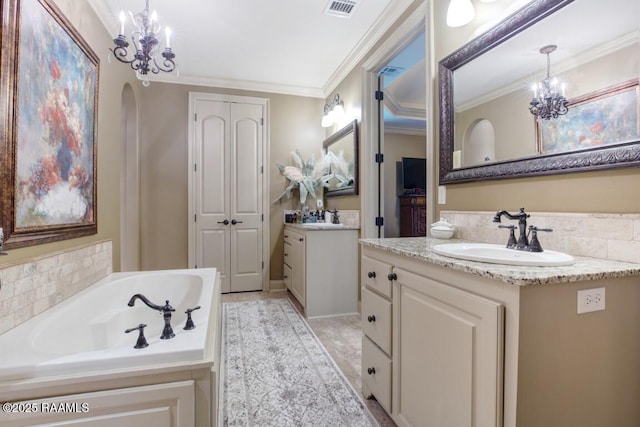 bathroom featuring a chandelier, visible vents, ornamental molding, and a sink