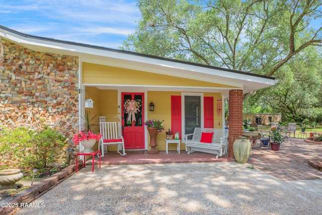 view of front of house with covered porch and stone siding