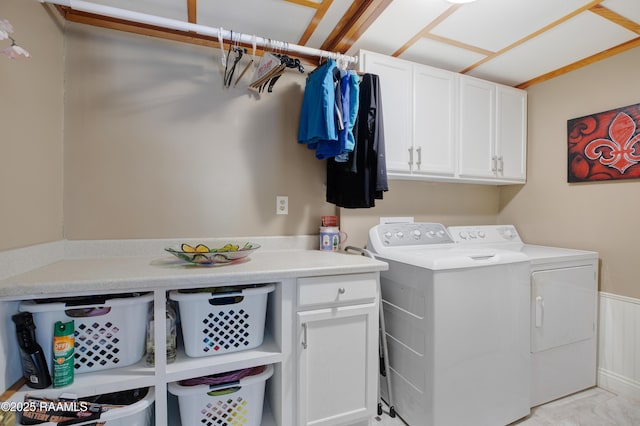 laundry room with washing machine and dryer and cabinet space