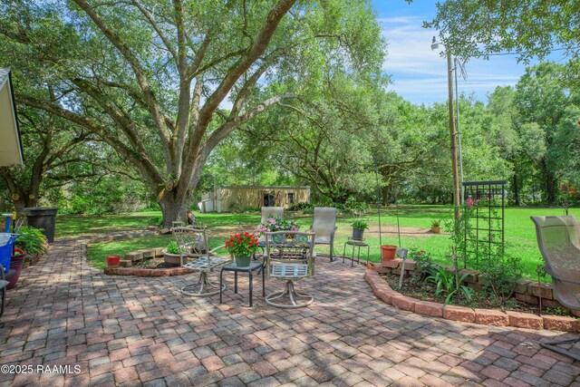 view of patio with an outbuilding